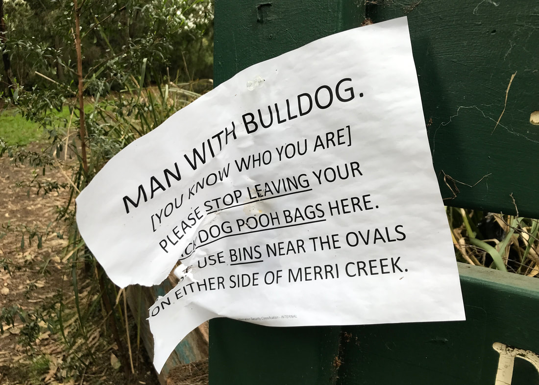 Home-printed sign - MAN WITH BULLDOG. [YOU KNOW WHO YOU ARE] PLEASE STOP LEAVING YOUR DOG POOH BAGS HERE. USE BINS NEAR THE OVALS ON EITHER SIDE OF MERRI CREEK.