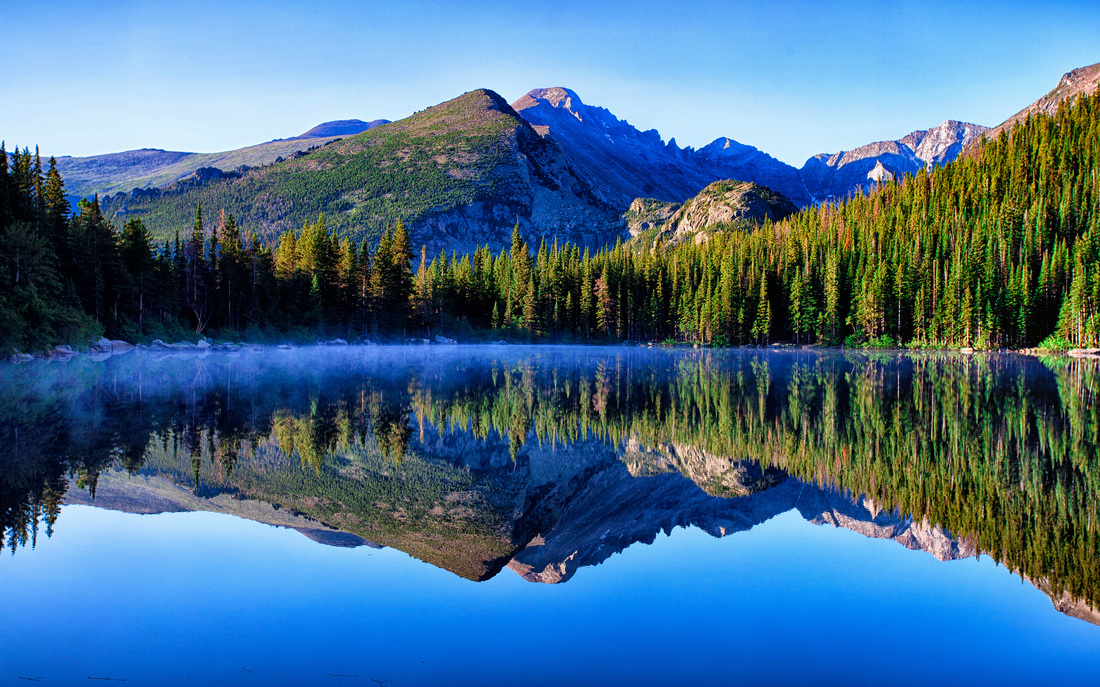 Mountains reflected in still lake