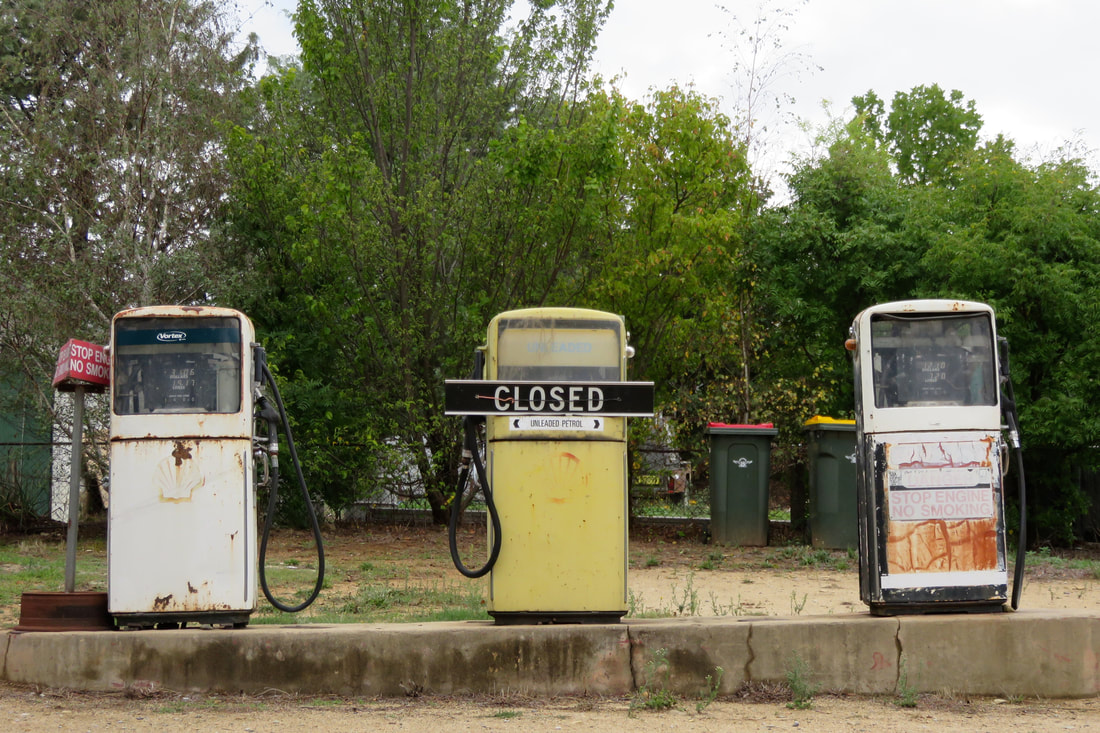 three old, disused petrol pumps