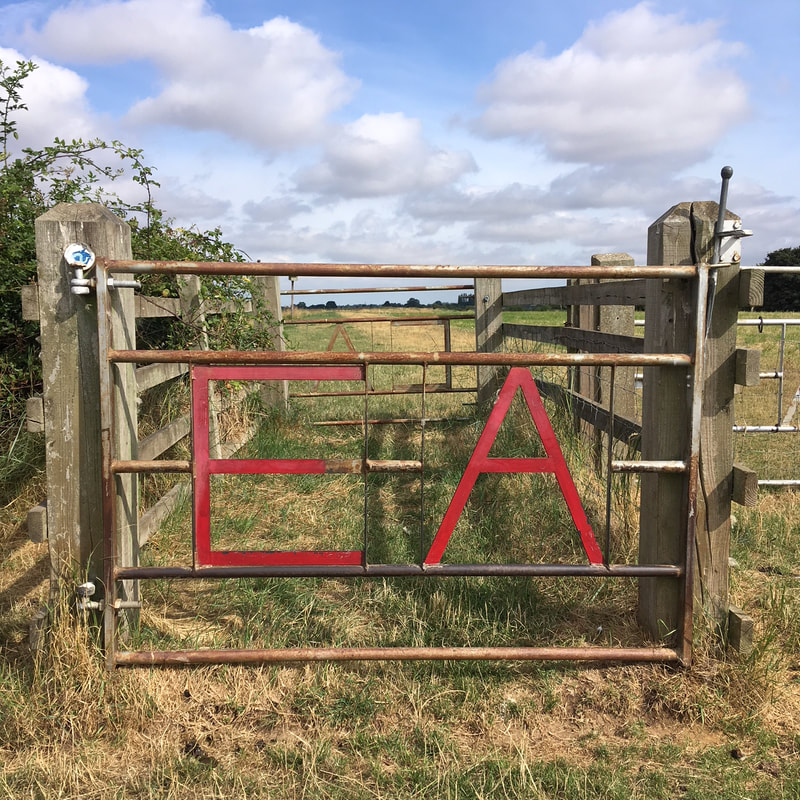 Barred gate with EA in red text
