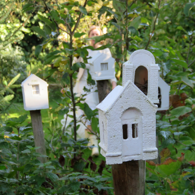 small ceramic chapels on posts