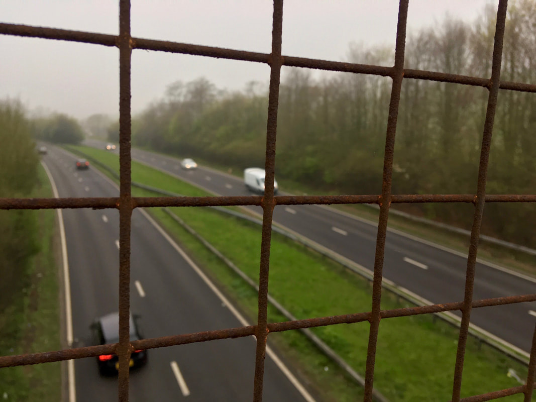 Dual carriageway seen through wire mesh from above