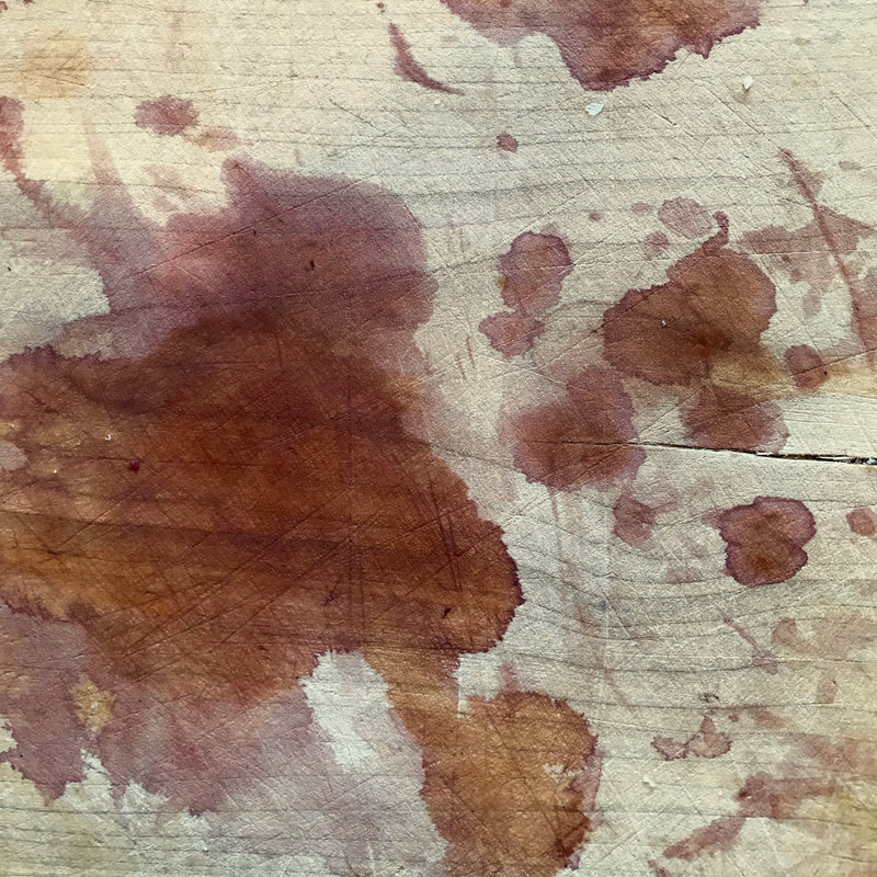Wooden chopping board with splotchy stains