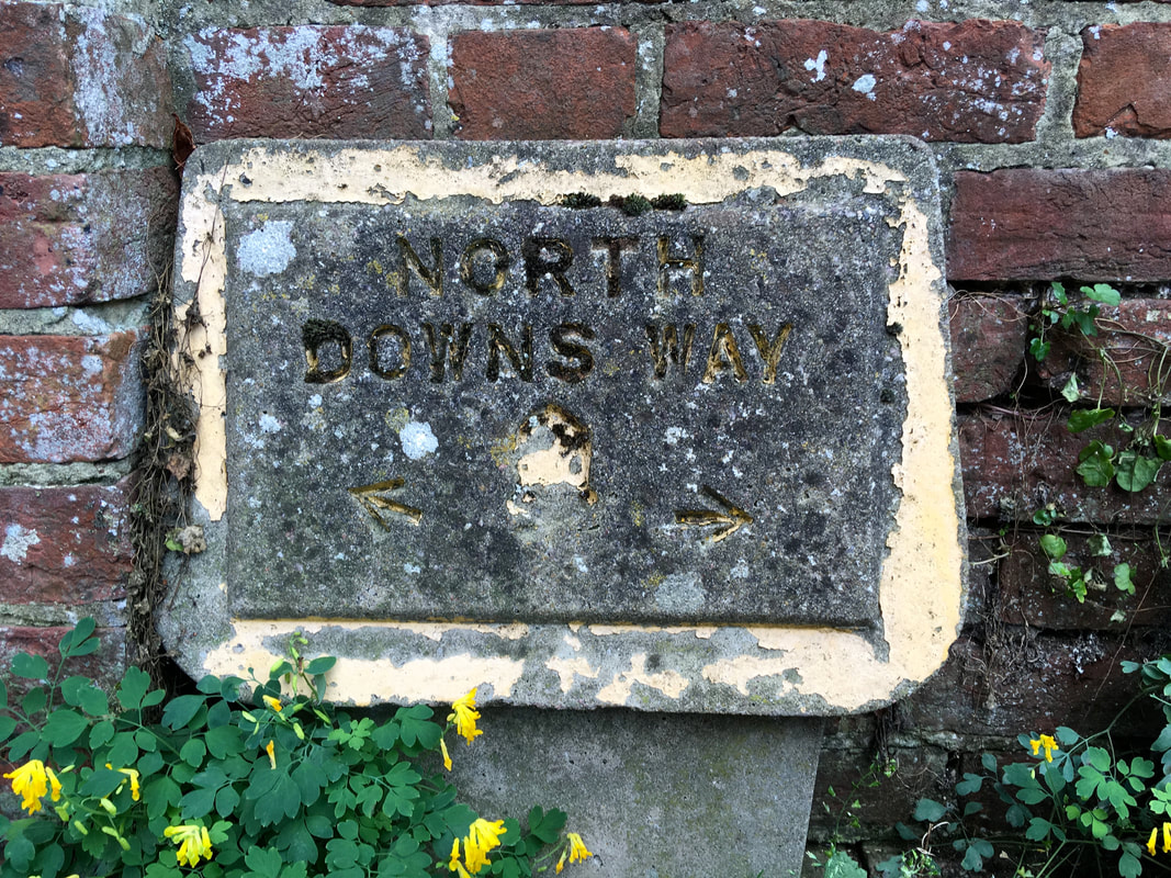 Concrete sign saying North Downs Way