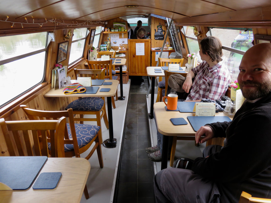 Cafe in a long, narrow boat lined with pine