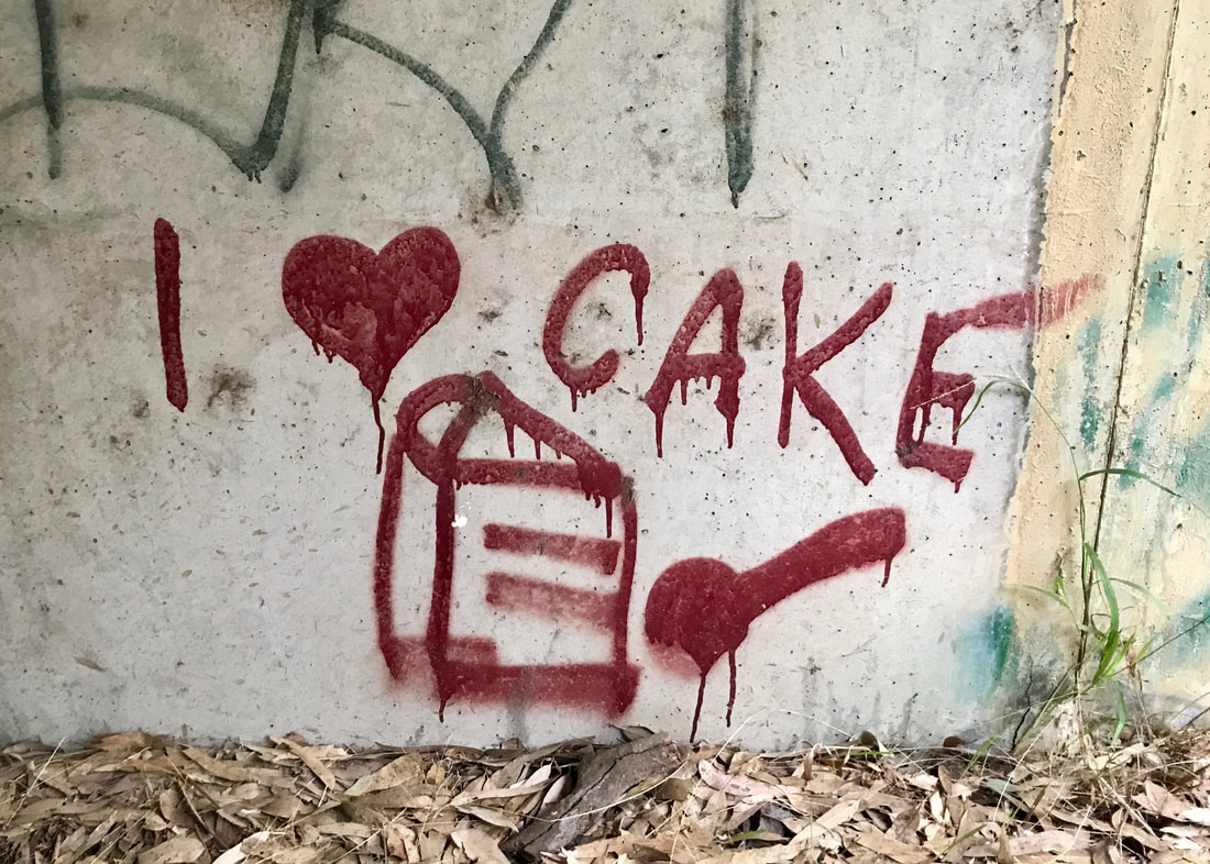 messy red graffiti: i heart cake, and a line drawing of a slice of cake