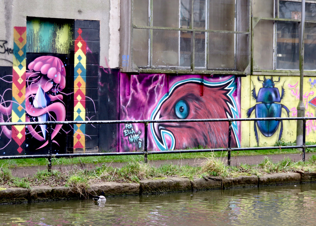 Colourful canalside graffiti of creatures