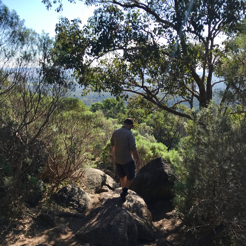 Person climbing down a rocky path