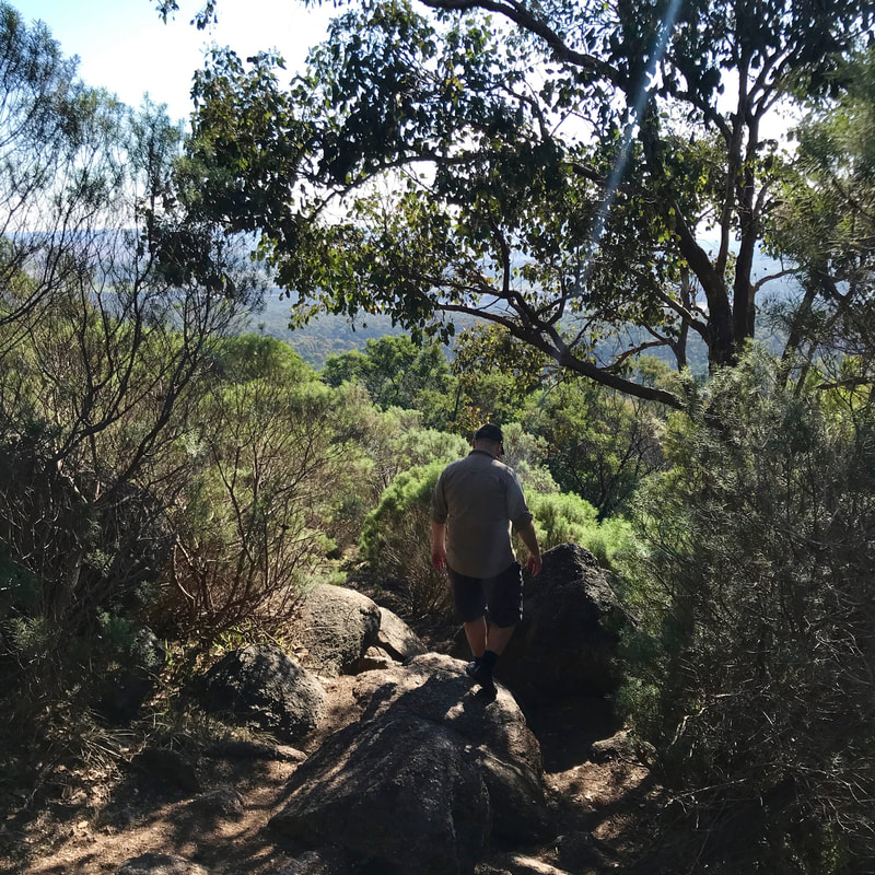 Person climbing down a rocky path
