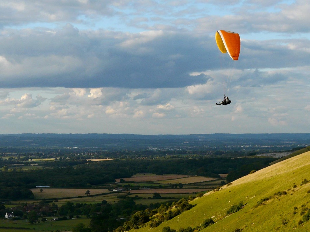 Paraglider and view from hill