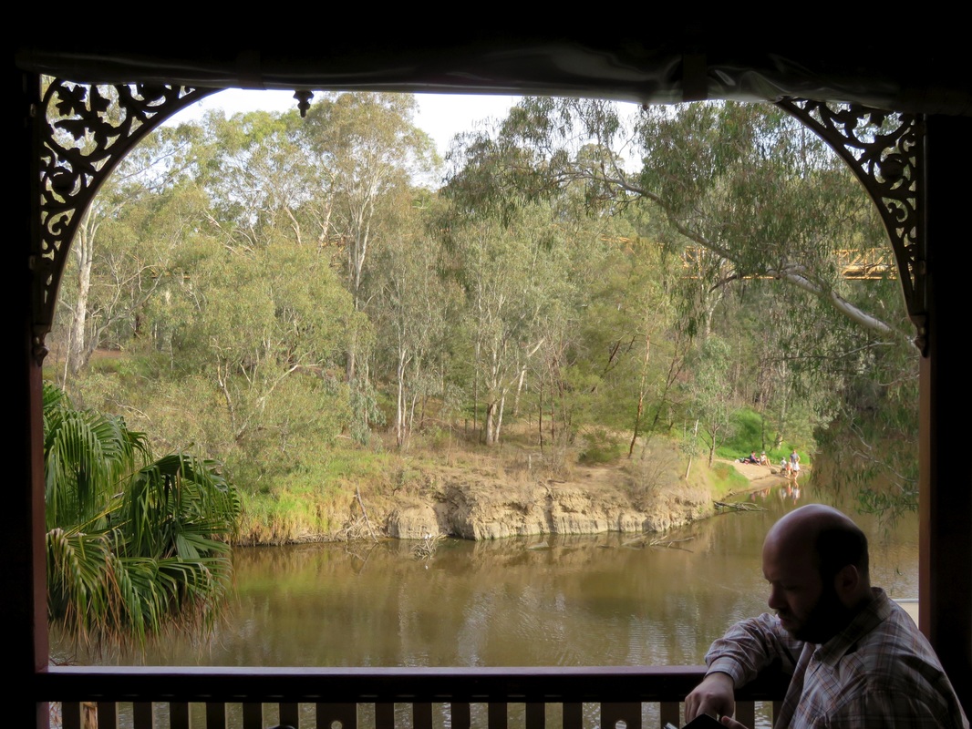 Brown river framed with lace verandah