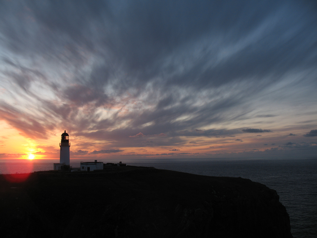Silhouetted lighthouse and sunset