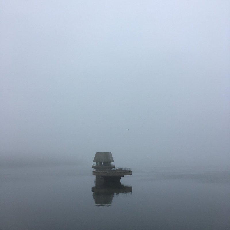 Reservoir building in grey mist