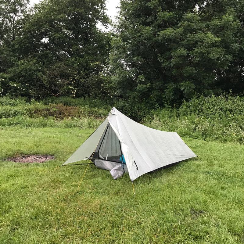 Side view of tent with grass and trees