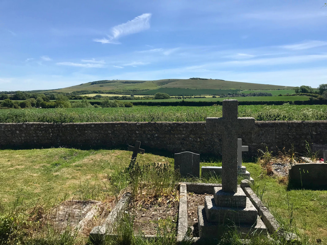 rolling hills with stone wall and crosses in foreground