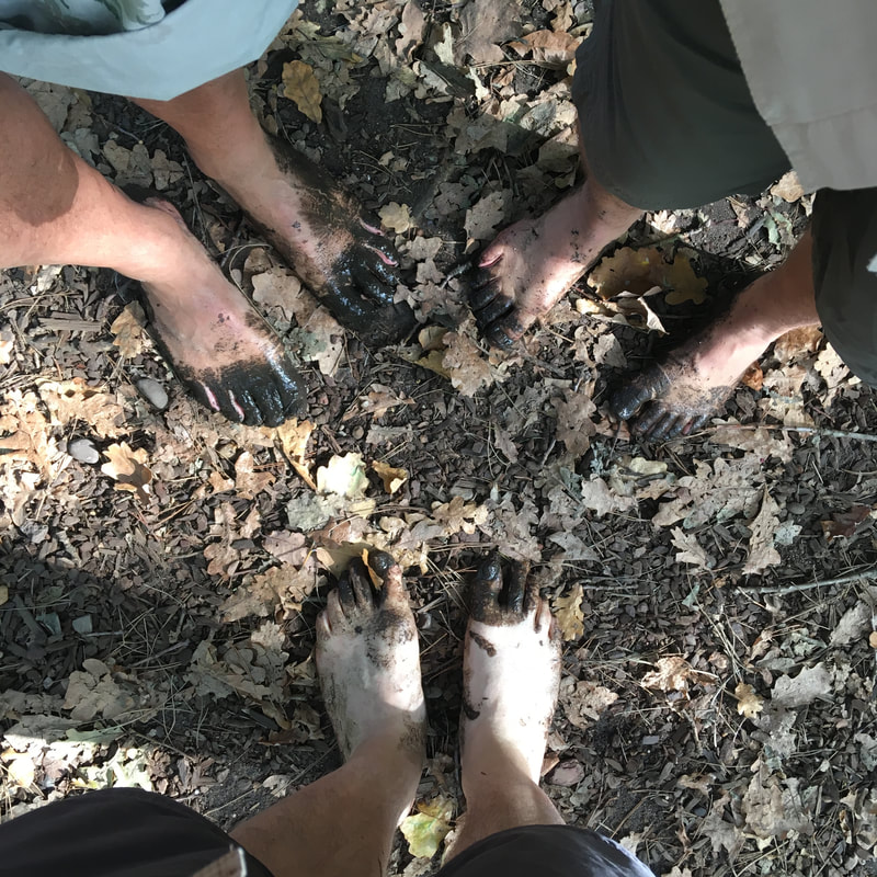 three pairs of muddy feet