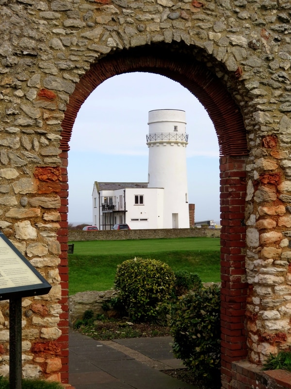 lighthouse seen through arch