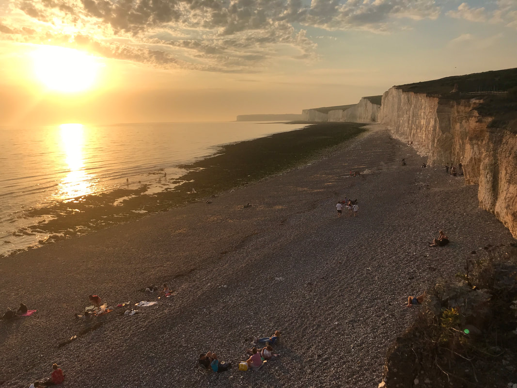 Sunset over a beach backed with white cliffs